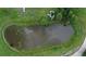 An overhead view of a serene pond, bordered by lush grass at 7029 Dormany Loop, Plant City, FL 33565