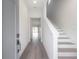 Bright and airy entryway with hardwood floors and staircase at 5530 N 9Th St # 5, Tampa, FL 33604