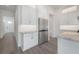 Well-lit kitchen featuring white cabinets, stainless steel refrigerator, and modern backsplash at 5530 N 9Th St # 5, Tampa, FL 33604