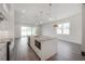 Open-concept kitchen has an island, sleek appliances, and contemporary finishes at 5530 N 9Th St # 5, Tampa, FL 33604