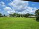 Expansive grassy backyard with view of neighboring houses at 13417 Whitehaven Ct, Spring Hill, FL 34609