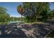 Paved path alongside a tranquil lake, surrounded by palm trees and shade trees at 5530 N 9Th St # 5, Tampa, FL 33604