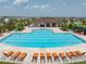 Community pool with lounge chairs and a pool house at 5474 Leslie Canyon Dr, Wimauma, FL 33598