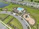 Aerial view of community pool, playground, and parking at 5474 Leslie Canyon Dr, Wimauma, FL 33598