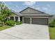 A charming two-story house with a two-car garage and landscaped yard at 5474 Leslie Canyon Dr, Wimauma, FL 33598