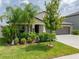House exterior featuring a well-manicured lawn and lush landscaping at 5474 Leslie Canyon Dr, Wimauma, FL 33598