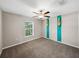 Bedroom with ceiling fan and teal accent wall at 5474 Leslie Canyon Dr, Wimauma, FL 33598
