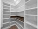 Bright walk-in pantry with white shelving and wood countertop at 5474 Leslie Canyon Dr, Wimauma, FL 33598