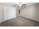 Bright bedroom featuring a ceiling fan and access to hallway at 5474 Leslie Canyon Dr, Wimauma, FL 33598