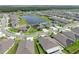 Aerial view of a house with solar panels, showcasing the property and surrounding neighborhood at 5474 Leslie Canyon Dr, Wimauma, FL 33598
