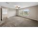 Primary bedroom with carpet flooring and two windows at 5474 Leslie Canyon Dr, Wimauma, FL 33598