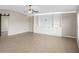 Bright living room featuring built-in shelving and tile flooring at 5474 Leslie Canyon Dr, Wimauma, FL 33598