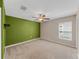 Bedroom with ceiling fan, carpet, and accent wall at 5474 Leslie Canyon Dr, Wimauma, FL 33598