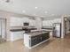 Spacious kitchen featuring granite island, stainless steel appliances, and white cabinetry at 5474 Leslie Canyon Dr, Wimauma, FL 33598