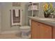Clean bathroom with a toilet, vanity, and shelving for toiletries at 549 Bahia Beach Blvd, Ruskin, FL 33570