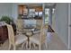 Small dining area with glass-top table and four chairs at 549 Bahia Beach Blvd, Ruskin, FL 33570