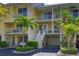 Two-story townhouse with private entrance, garage, and tropical landscaping at 549 Bahia Beach Blvd, Ruskin, FL 33570