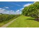 Landscaped lawn and walkway leading to waterfront community at 549 Bahia Beach Blvd, Ruskin, FL 33570