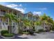 Two-story building with multiple units, balconies, and tropical landscaping at 549 Bahia Beach Blvd, Ruskin, FL 33570