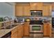 Well-equipped kitchen featuring stainless steel appliances and light wood cabinets at 549 Bahia Beach Blvd, Ruskin, FL 33570