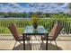 Waterfront balcony with table and chairs, offering scenic water views at 549 Bahia Beach Blvd, Ruskin, FL 33570