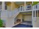 Private entrance to a townhouse with attached garage and bench at 549 Bahia Beach Blvd, Ruskin, FL 33570