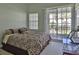 Spacious bedroom with a comfortable bed and access to a private balcony at 549 Bahia Beach Blvd, Ruskin, FL 33570