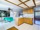 Eat-in kitchen with wood cabinets, tile floors, and breakfast bar at 9408 Oak St, Riverview, FL 33578