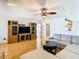 Living room with hardwood floors, large sectional sofa, and built-in entertainment center at 9408 Oak St, Riverview, FL 33578