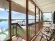 Covered porch with water views and seating at 9408 Oak St, Riverview, FL 33578