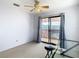 Bedroom with balcony access, desk, and ceiling fan at 9408 Oak St, Riverview, FL 33578