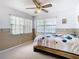 Bright bedroom with window, ceiling fan, and carpeted floor at 9408 Oak St, Riverview, FL 33578