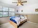 Bedroom with wood floors, ceiling fan, and large windows at 9408 Oak St, Riverview, FL 33578
