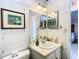 Bathroom with sink, toilet, and nautical-themed wallpaper at 9408 Oak St, Riverview, FL 33578