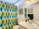 Clean bathroom with shower, patterned curtain, and vanity at 9408 Oak St, Riverview, FL 33578