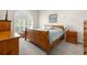 Main bedroom with a wooden sleigh bed and plenty of natural light at 35506 Wickingham Ct, Zephyrhills, FL 33541