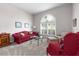 Living room with red sofa and armchairs at 35506 Wickingham Ct, Zephyrhills, FL 33541