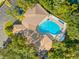 Aerial view of community pool and surrounding building at 35506 Wickingham Ct, Zephyrhills, FL 33541