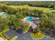 Aerial view of community pool, clubhouse, and parking lot at 35506 Wickingham Ct, Zephyrhills, FL 33541