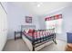 Guest bedroom with a metal bed frame and a calming color scheme at 35506 Wickingham Ct, Zephyrhills, FL 33541