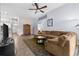 Open living room showcasing a cozy sectional sofa and views to other rooms at 35506 Wickingham Ct, Zephyrhills, FL 33541