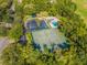 Aerial view of tennis courts, pool, playground, and parking at 35506 Wickingham Ct, Zephyrhills, FL 33541