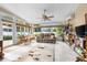Sunroom with ample natural light, comfortable seating, and built-in shelving at 35506 Wickingham Ct, Zephyrhills, FL 33541