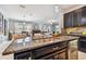 Granite kitchen island with double sink overlooks Gathering room at 10012 Sage Creek Dr, Ruskin, FL 33573