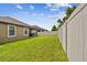 Expansive grassy backyard with a privacy fence at 10012 Sage Creek Dr, Ruskin, FL 33573