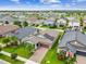 Aerial view of a house with solar panels and a red door at 10012 Sage Creek Dr, Ruskin, FL 33573