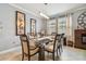 Bright dining room features a glass-top table and comfortable seating for six at 10012 Sage Creek Dr, Ruskin, FL 33573