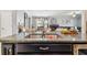 Kitchen island features a double sink and granite countertop at 10012 Sage Creek Dr, Ruskin, FL 33573