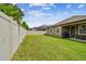 Fenced-in backyard featuring a grassy lawn and patio area at 10012 Sage Creek Dr, Ruskin, FL 33573