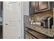 Kitchen features dark cabinetry, granite countertops and a coffee bar area at 10012 Sage Creek Dr, Ruskin, FL 33573